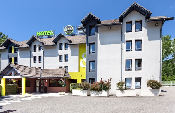 A multi-story hotel with a modern design, featuring a prominent 'HOTEL' sign and a B&B logo. - B&B HOTEL Chambéry La Cassine (Chambery)