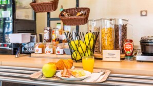 A breakfast buffet with various food items and condiments. - B&B HOTEL Chambéry La Cassine (Chambery)