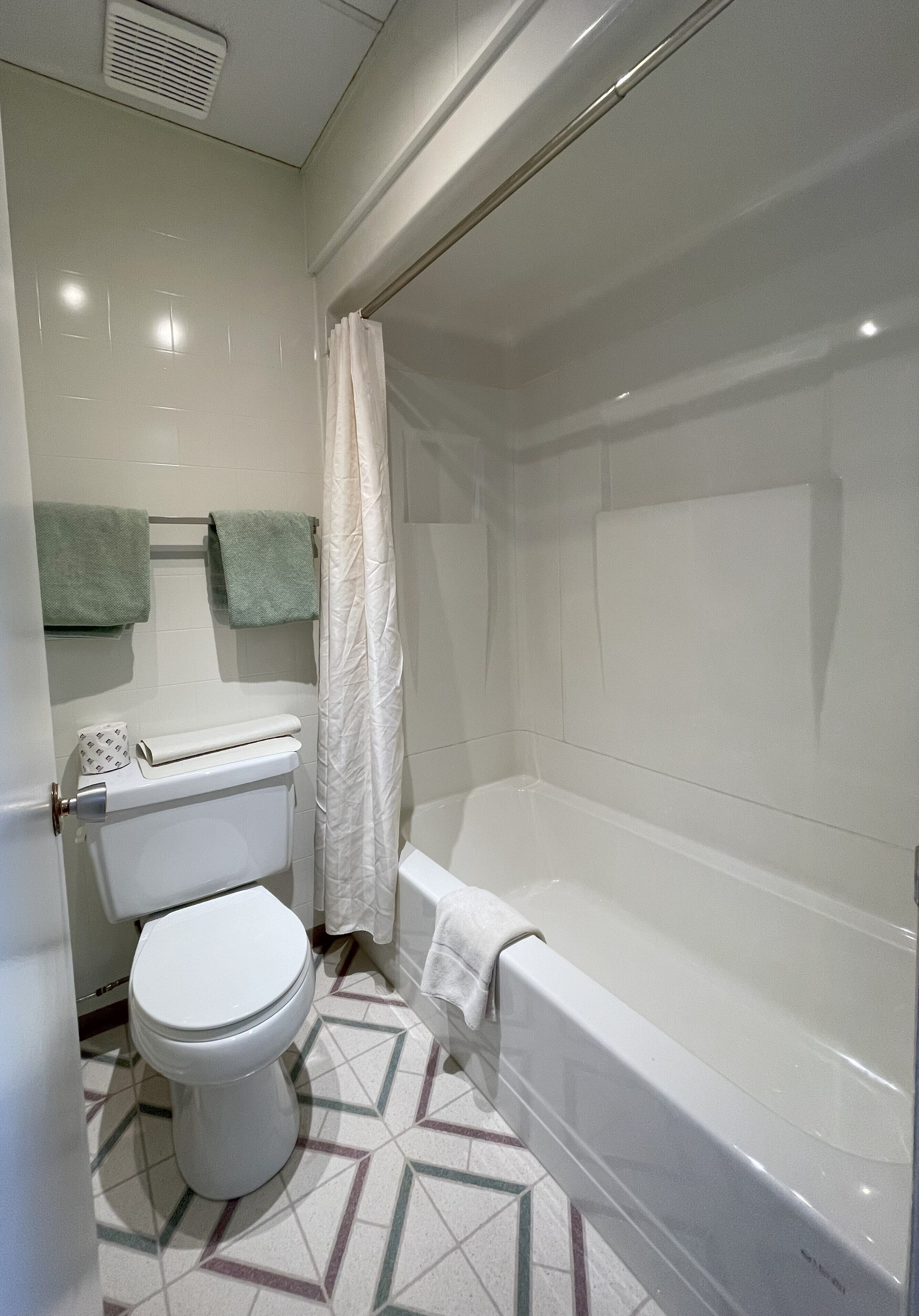 double room, 2 queen beds | bathroom | combined shower/bathtub, towels