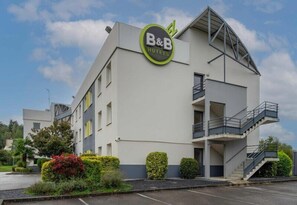 A B&B hotel with a modern design, a balcony, and a staircase.