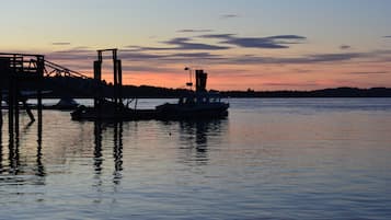 A dock with a boat and a pier structure during sunset.