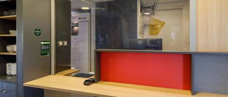 A reception desk with a sign indicating the date and time.