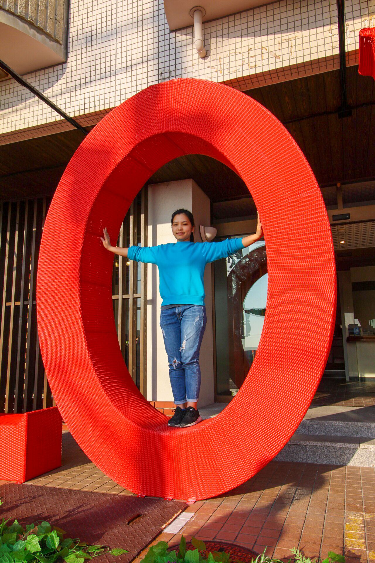 A person standing inside a large red circular structure.