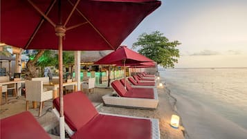 On the beach, white sand, sun-loungers, beach umbrellas