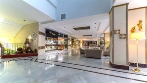 A spacious lobby with a marble floor, a staircase, a jewelry store, and seating areas. - Lâ€™ETOILE BEACH HOTEL - All inclusive (Marmaris)