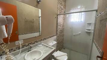 A bathroom with a sink, toilet, and shower.