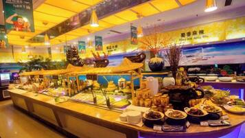 A buffet area with various food items and a decorative centerpiece.