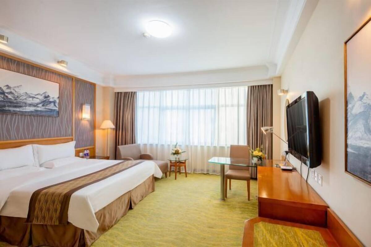 Relax in comfort with a large bed, flat-screen TV, and a cozy reading nook.