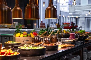A buffet setup with various food items and cooking utensils. - Radisson Blu Metropol Hotel, Helsingborg (Helsingborg)