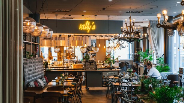 A restaurant interior with a bar area, seating arrangements, and a neon sign. - Radisson Blu Metropol Hotel, Helsingborg (Helsingborg)