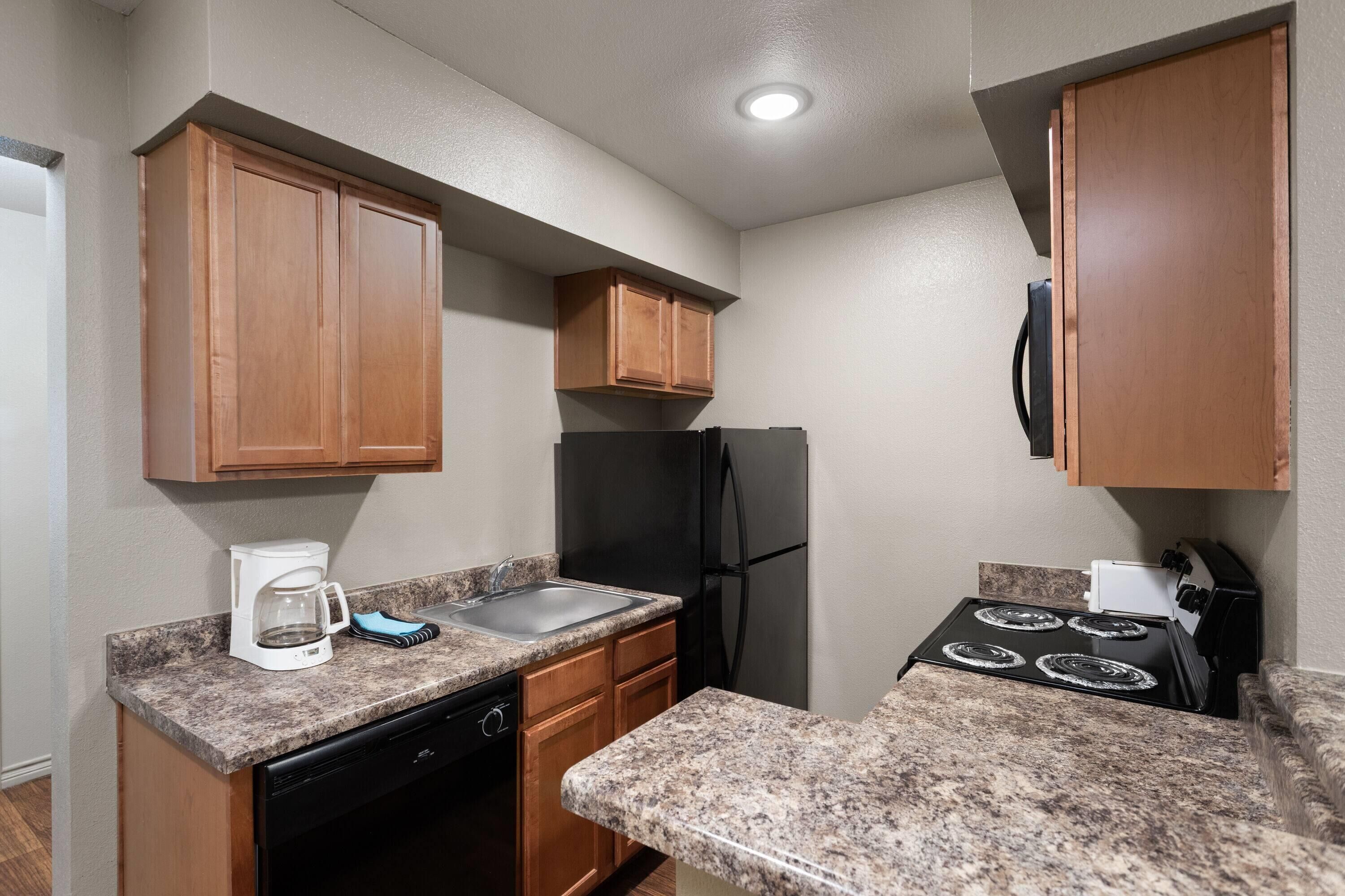 full-sized fridge, microwave, stovetop, dishwasher