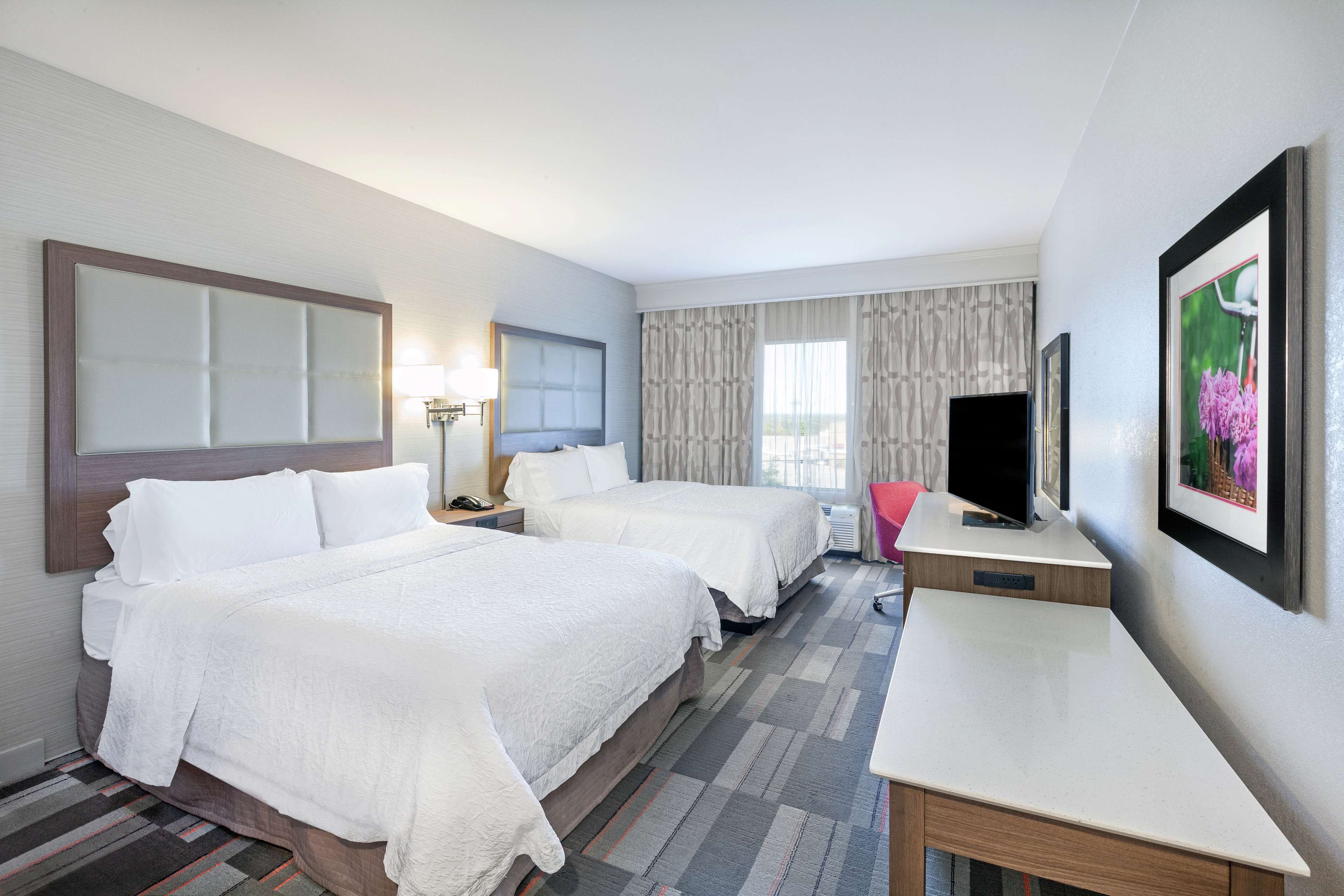 room, 2 queen beds, refrigerator | in-room safe, soundproofing, iron/ironing board, cots/infant beds