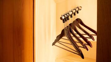 A wooden door with a metal rack holding several black and brown skis.