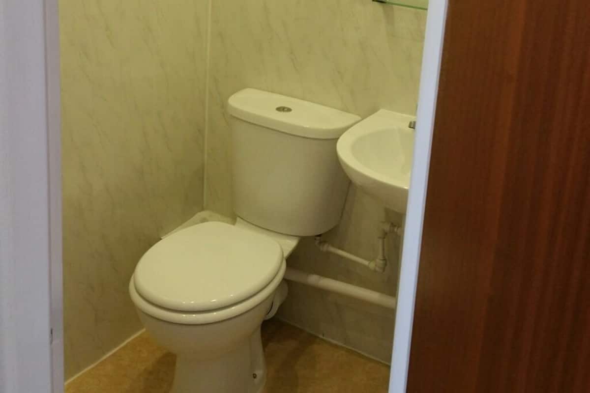 A small bathroom with a toilet and sink.
