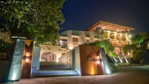 A hotel entrance with a grand staircase leading to a multi-story building, surrounded by lush greenery. - The Lady Hill Hotel (Galle)
