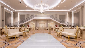 A grand ballroom with a central chandelier, a grand staircase, and elegant seating arrangements. - Radisson Blu Hotel, Jeddah Plaza (Jeddah)