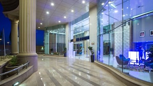 A spacious lobby with a polished marble floor, glass walls, and modern furniture. - Radisson Blu Hotel, Jeddah Plaza (Jeddah)