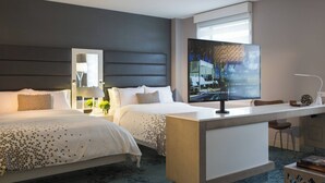 A hotel room with two beds, a TV, a desk, and a chair. - Renaissance Albany Hotel (Albany)