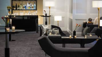 A modern lounge area with a bar, seating, and ambient lighting.
