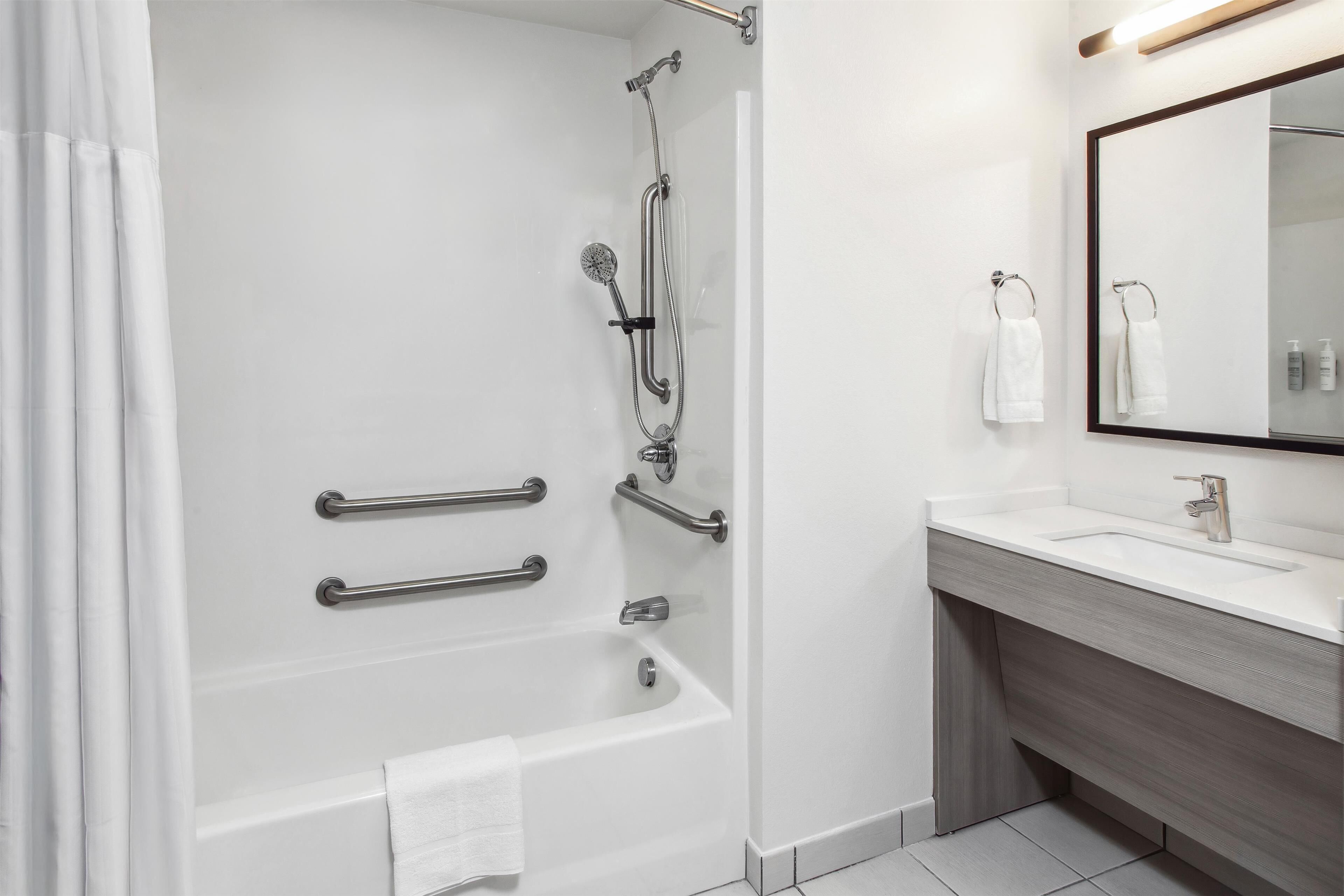 combined shower/bathtub, designer toiletries, hair dryer, towels