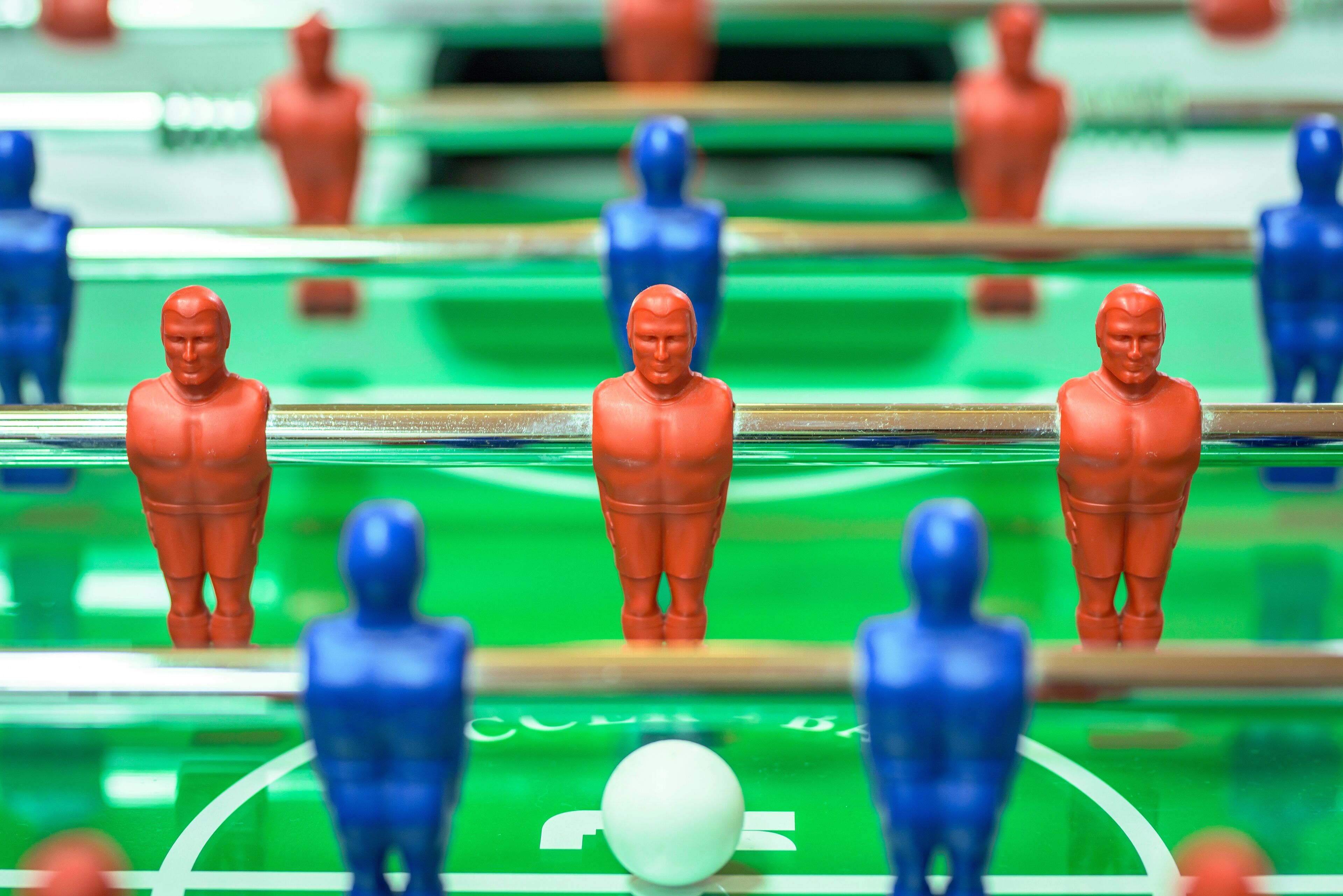 A foosball table with red and blue player figures.