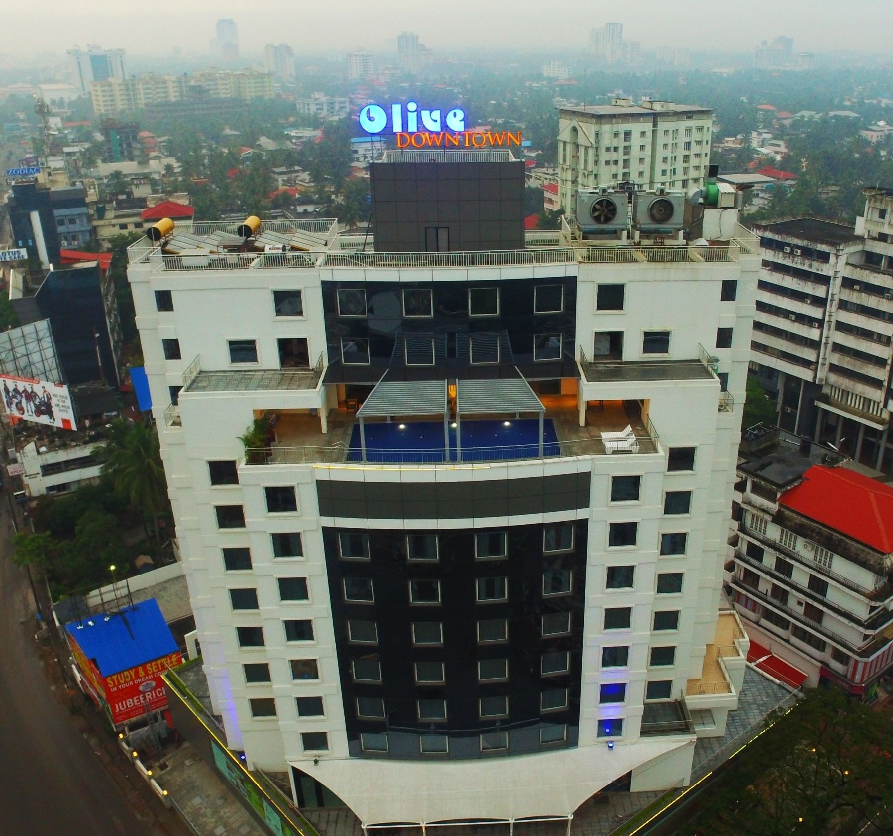 A multi-story building with a prominent sign for "Olive Downtown".