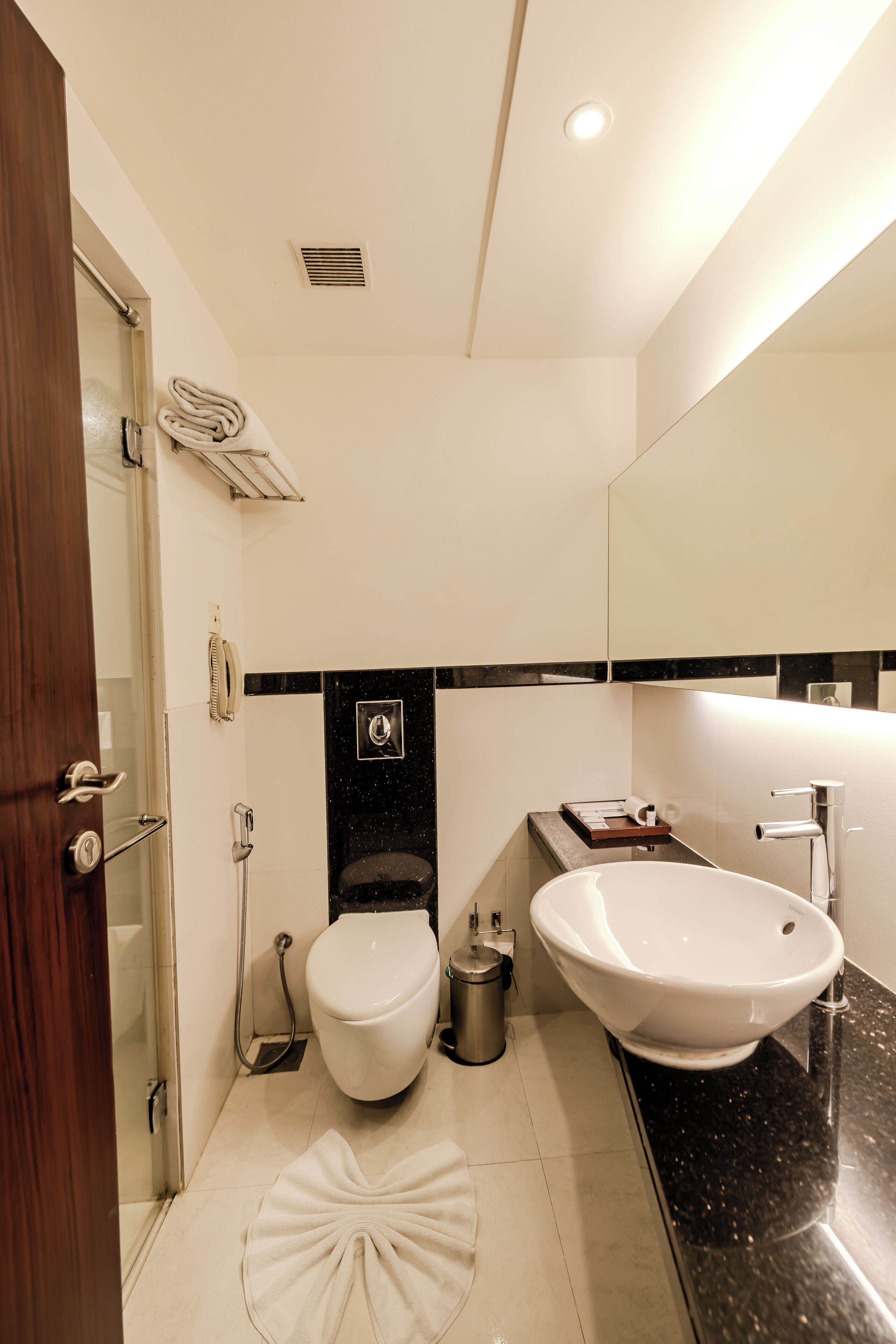 A modern bathroom with a toilet, bidet, and sink.