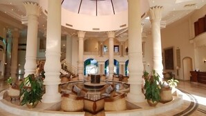 A grand lobby with a central fountain, high ceilings, and classical columns. - Life Resort Coral Hills - All inclusive (El Quseir)