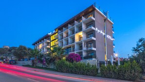 Un hôtel à plusieurs étages, doté de balcons, d’une façade en pierre et d’une enseigne indiquant qu’il s’agit d’un hôtel.