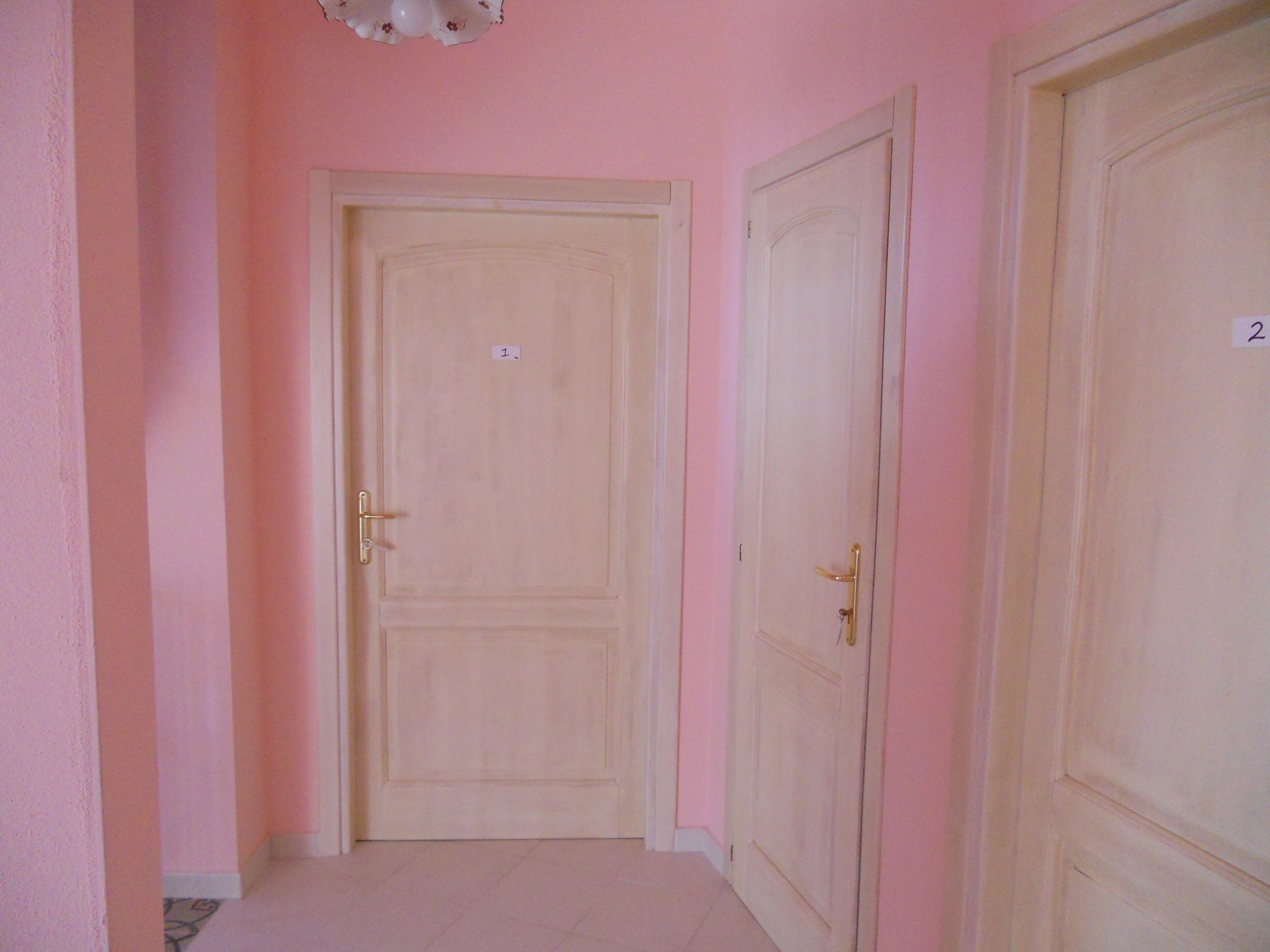 A hallway with two doors, each marked with a number.