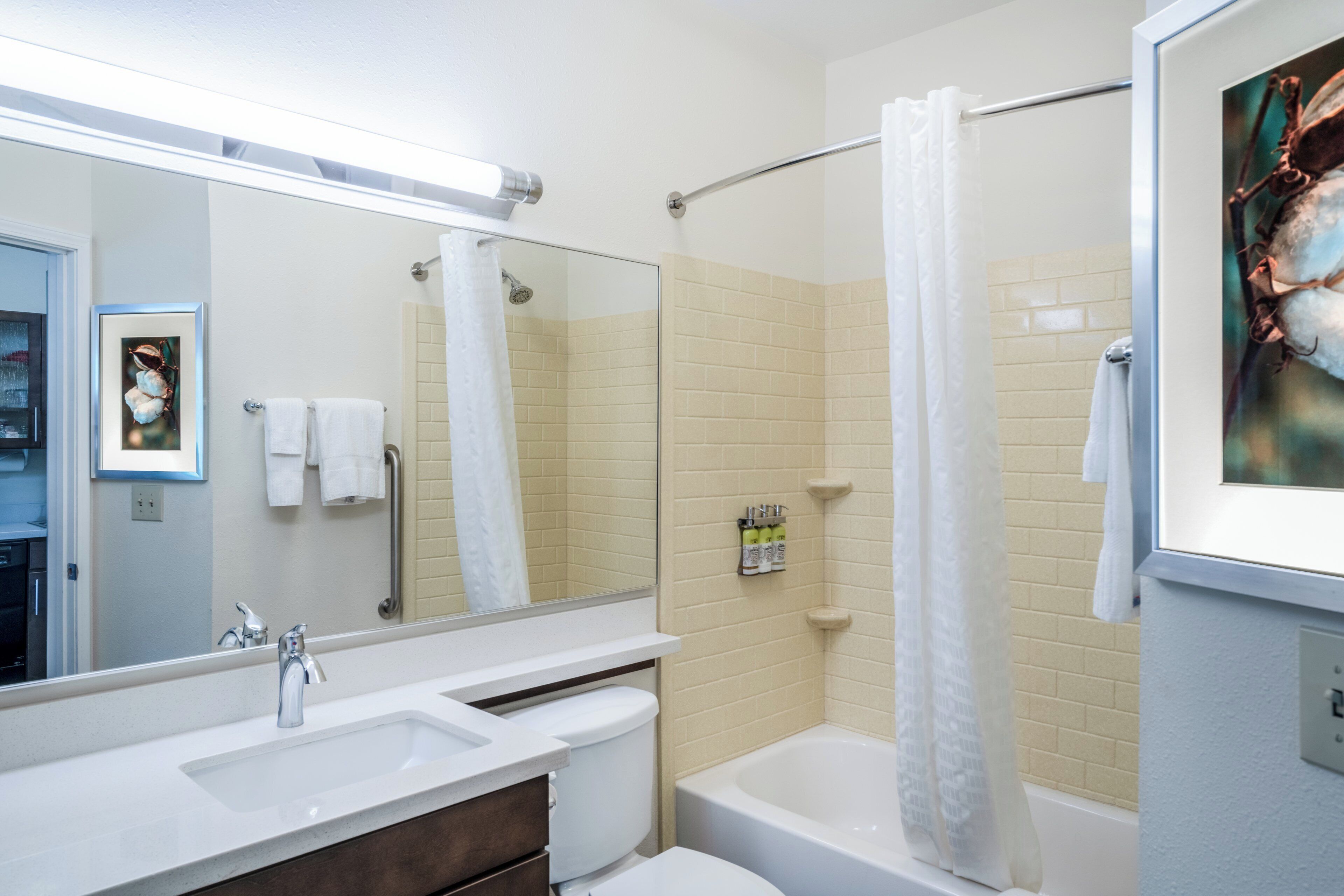 A bathroom with a sink, toilet, and bathtub.