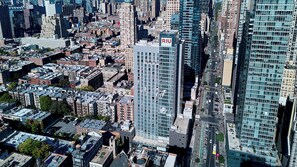 A high-rise building with a prominent 'RIU' sign, surrounded by dense urban architecture. - Hotel Riu Plaza New York Times Square (New York)