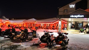 A hotel reception with a row of parked motorcycles outside.
