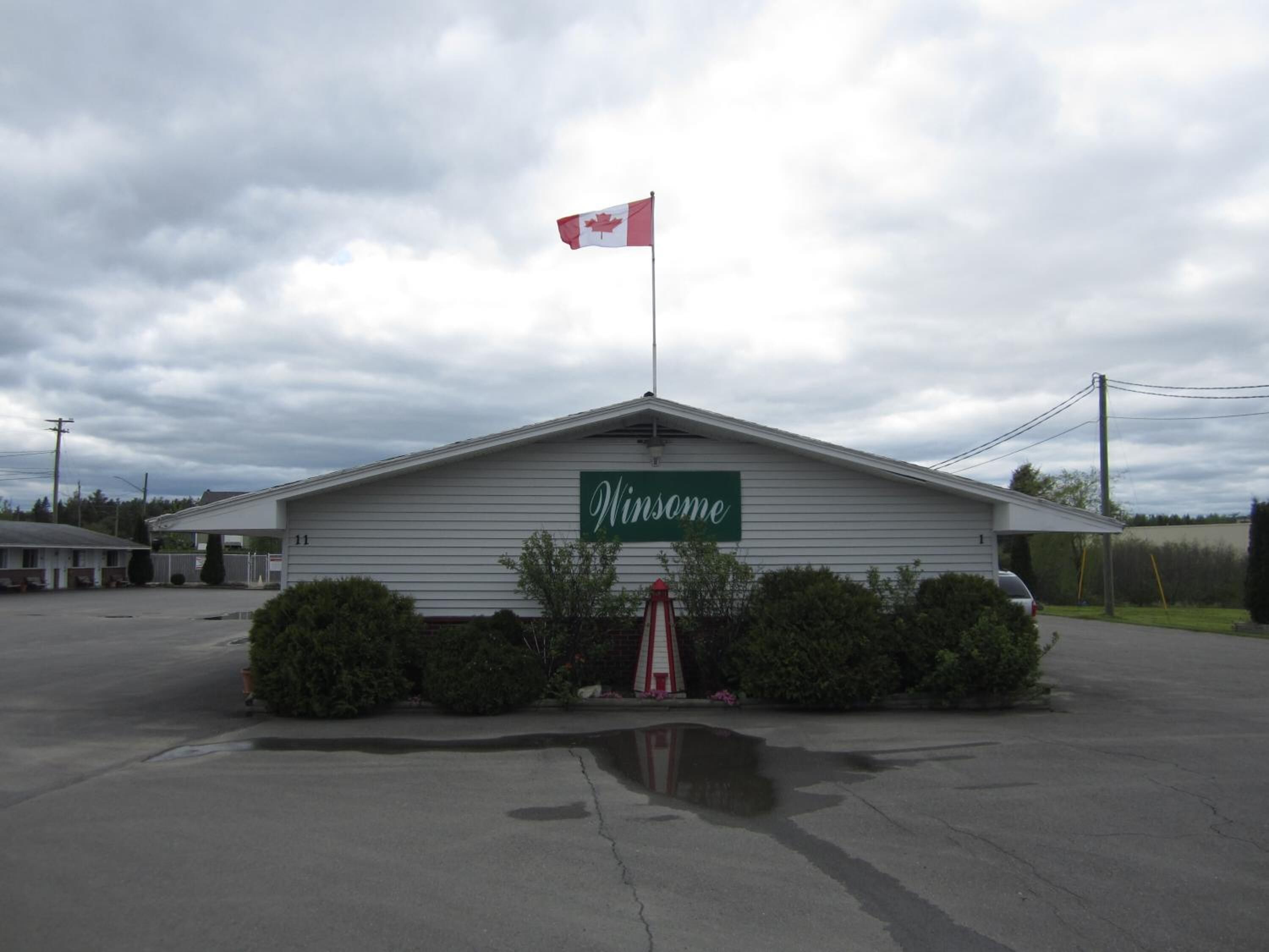 A building with a sign reading "Windsome" and a Canadian flag on top.