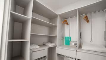 Un dressing avec plusieurs étagères, une tringle à vêtements et une coiffeuse intégrée dotée d’un miroir.