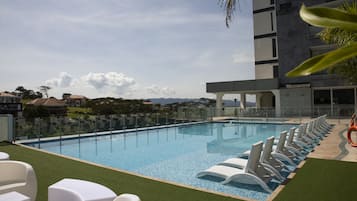 Outdoor pool, open 9:00 AM to 5:00 PM, pool loungers, lifeguards on site