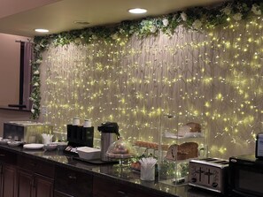 A breakfast bar with a decorative wall, a coffee machine, and a toaster.