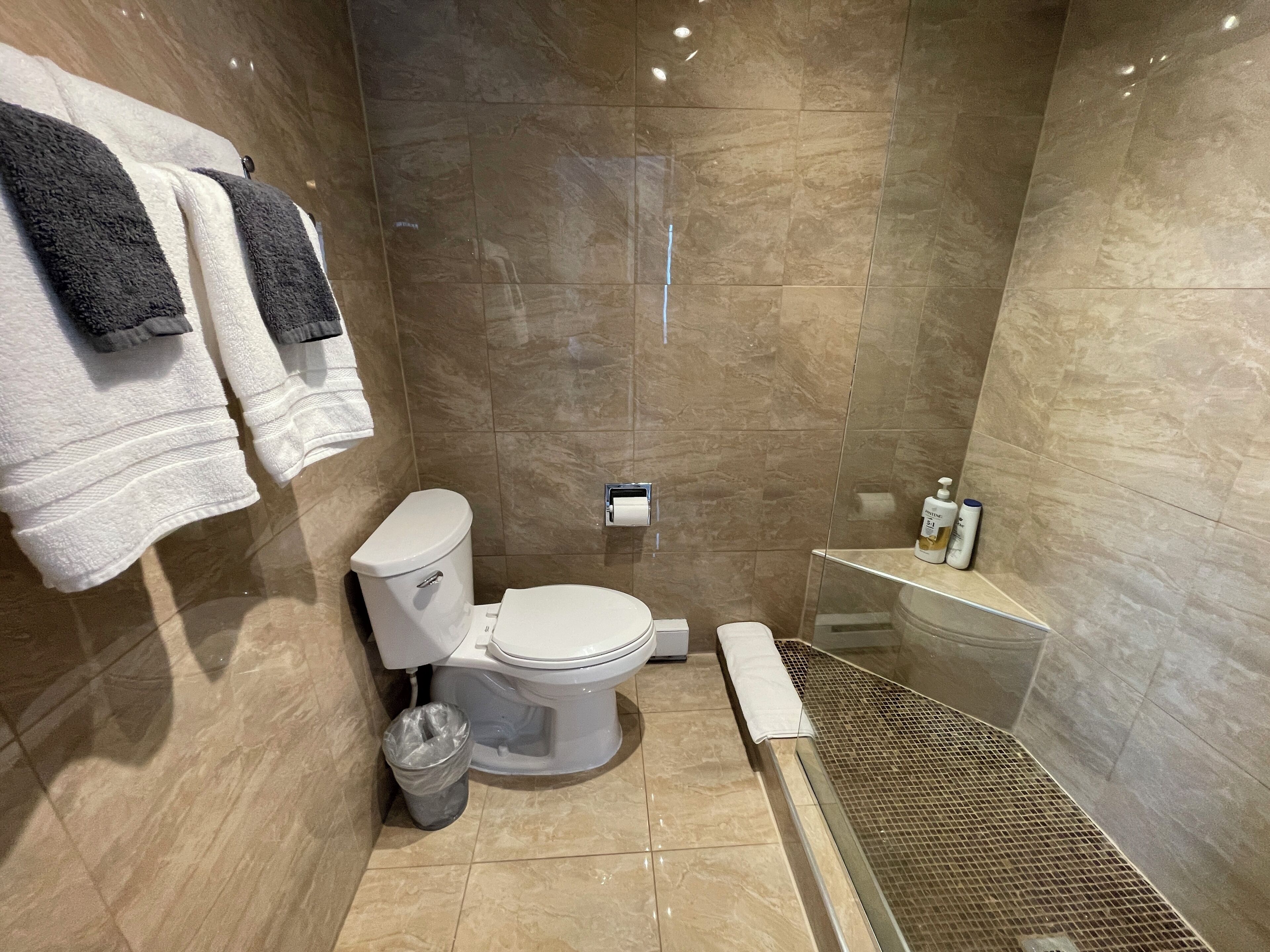 A modern bathroom with a toilet, sink, and shower area.