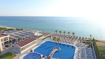 Outdoor pool, an infinity pool, pool umbrellas, pool loungers