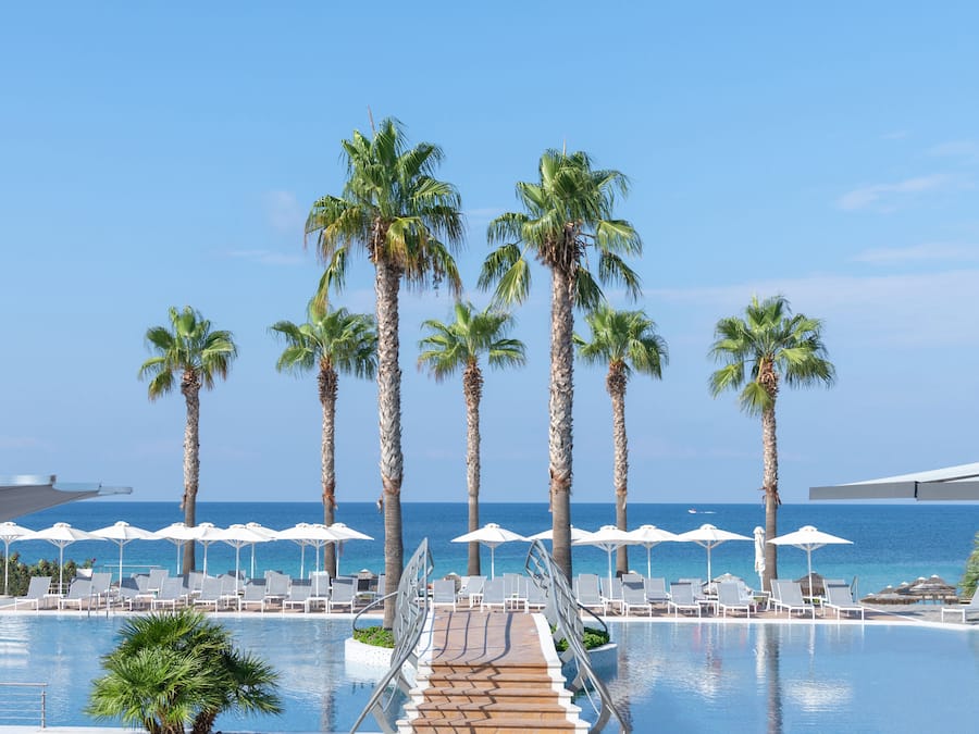 Outdoor pool, an infinity pool, pool umbrellas, sun loungers