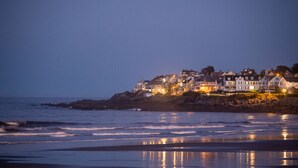 A coastal town with houses along the shore, reflecting on the water. - Union Bluff Hotel & Meeting House (York Beach)