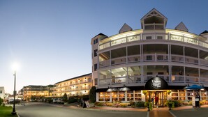A multi-story hotel with a prominent sign for Union Bluff Hotel, featuring balconies and a well-lit entrance. - Union Bluff Hotel & Meeting House (York Beach)