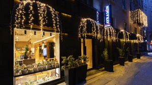 A hotel with large windows, potted plants, and decorative lights. - Ayramin Deluxe Hotel  (Istanbul)