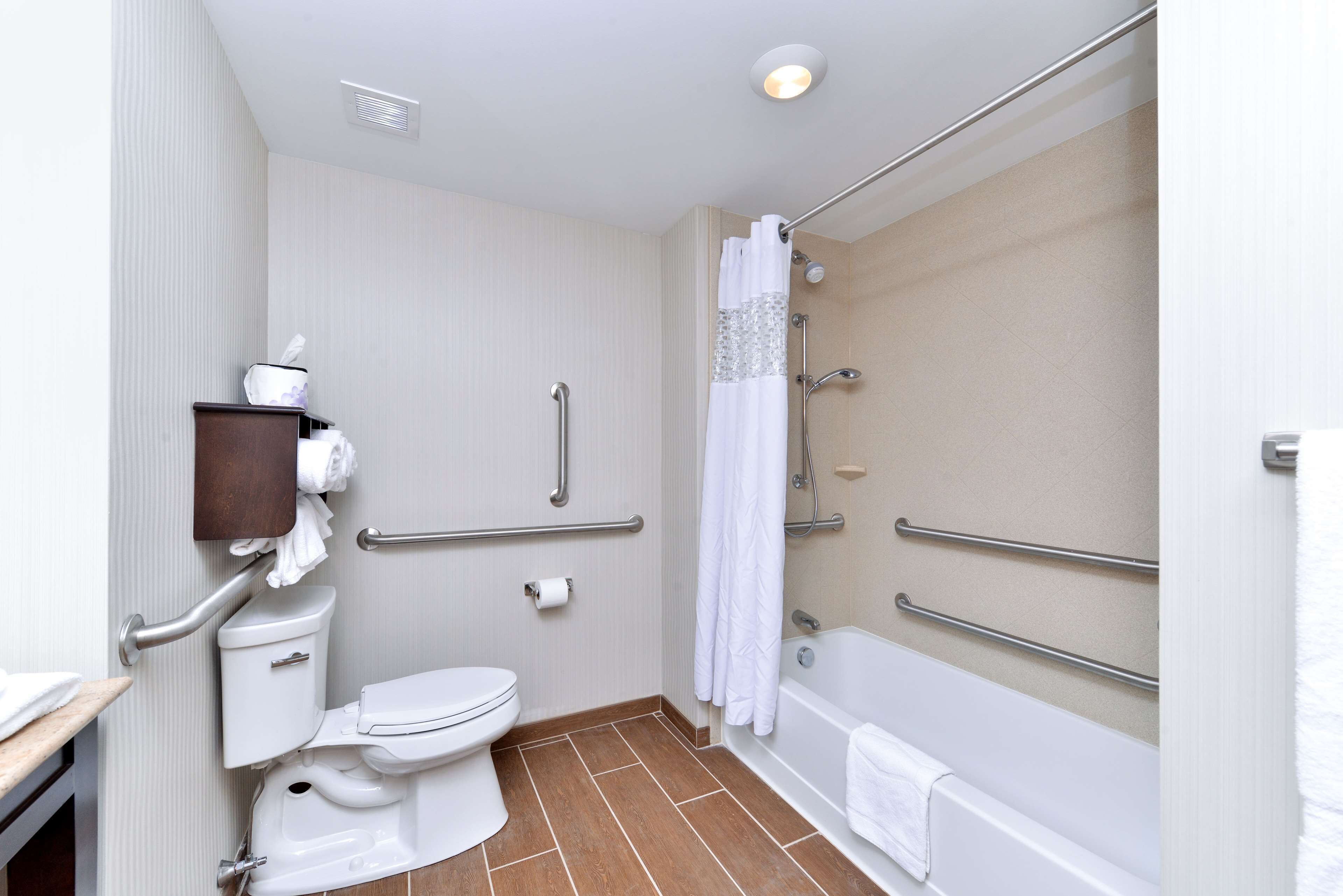 A bathroom with a toilet, a bathtub, and a shower.