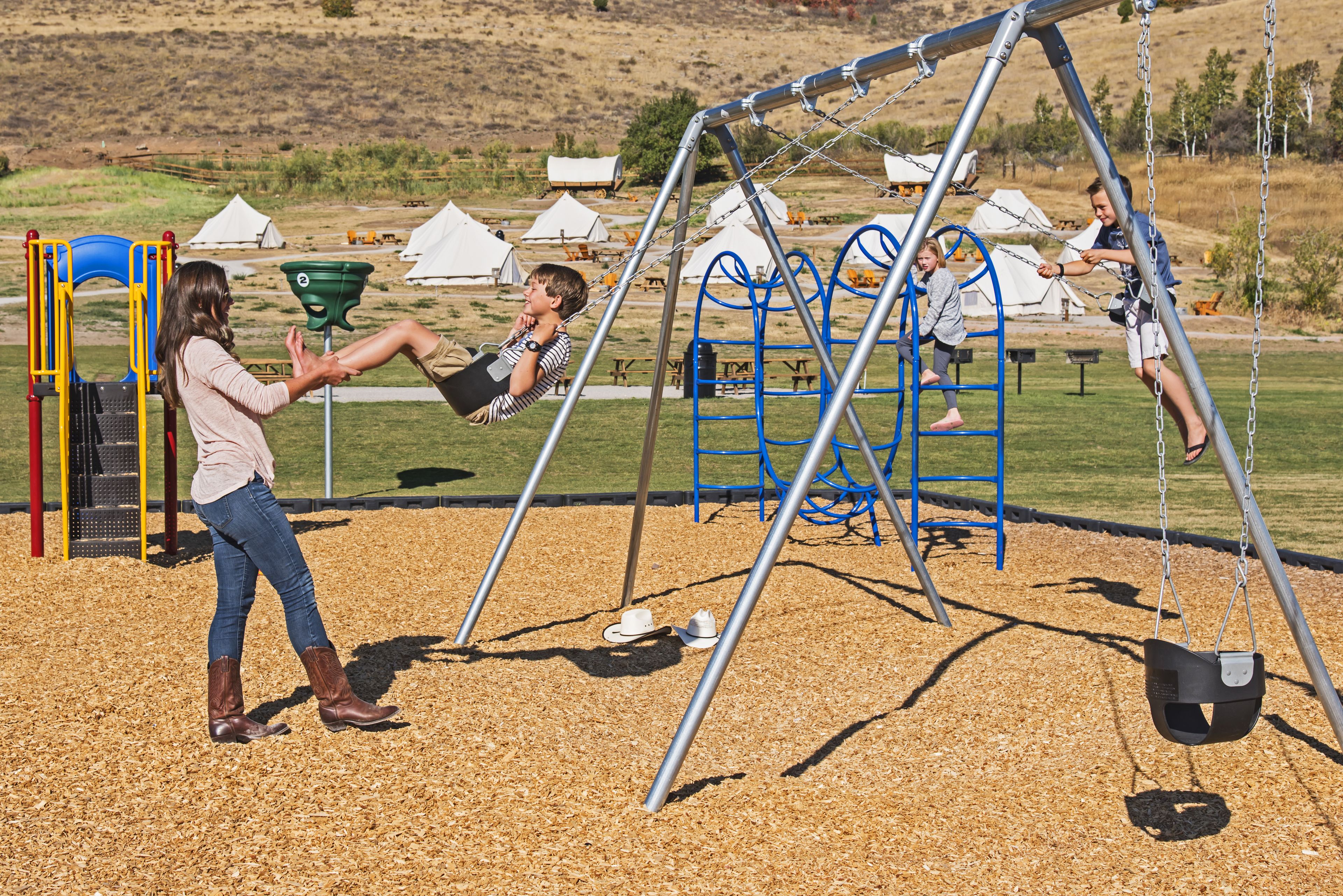 A playground with swings and a climbing structure.