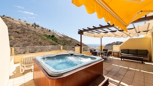 A rooftop terrace with a hot tub, outdoor seating, and a view of the sea. - Holiday Club Sol Amadores (Mogan)