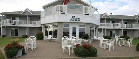 A motel with a bar, outdoor seating, and a landscaped garden.