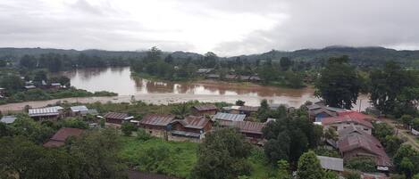 A river flowing through a village with houses on both sides.