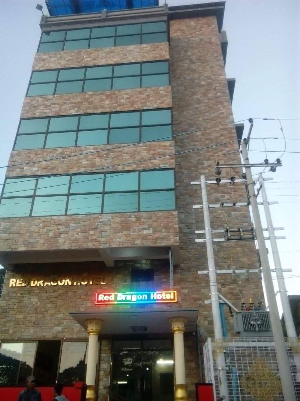 A multi-story hotel with a prominent sign reading 'Red Dragon Hotel.'