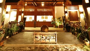 A wooden building with a covered entrance and potted plants. - Inle Lake View Resort & Spa (Nyaungshwe)